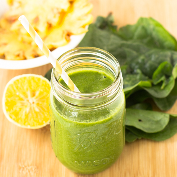This-Tropical-Green-Smoothie-is-one-of-my-favorite-green-smoothies-loaded-with-spinach-pineapples-orange-juice-and-bananas.-Its-only-255-calories-and-deliciously-smooth