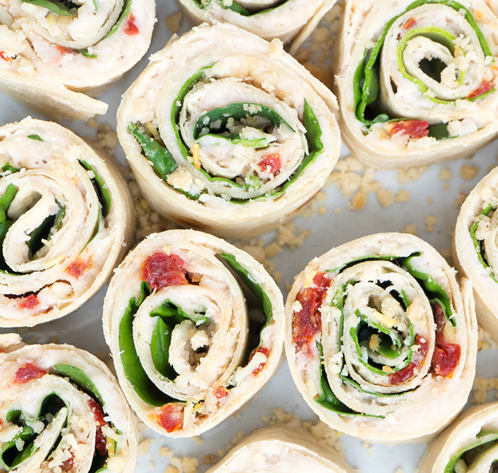These Sun-Dried Tomato, Basil and Spinach Pinwheels make a perfect party appetizer or light lunch. They take about 15 minutes to make and are a healthy alternative to pinwheels made with cream cheese. | APPETIZERS| LUNCH | VEGETARIAN | VEGAN | ROLL UPS | PINWHEELS | Recipe at OatandSesame.com