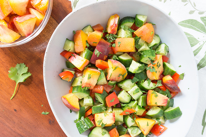 This Sweet Peach Cucumber Salad incorporates all the wonderful produce from your local farmer's market! Fresh cucumbers, red peppers, peaches and fresh herbs! Summer flavors that speak for themselves without any fuss. | GLUTEN FREE | VEGETARIAN | VEGAN | PLANT BASED | PEACHES | SALAD | HEALTHY | Recipe at OatandSesame.com