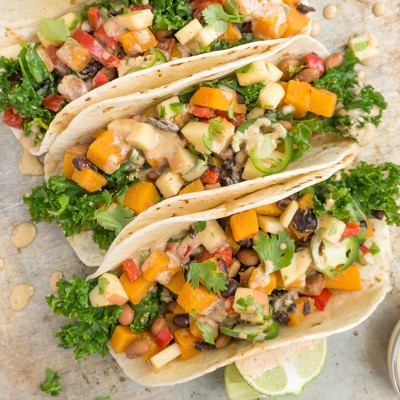 These Vegetarian Tacos with Black Beans are loaded with seasoned vegetables, topped with apples and finished with a smoky maple dressing for a seasonal twist. TacoTuesday should always be this healthy and delicious! | TACOS | VEGETARIAN | VEGAN | PLANT BASED | Recipe at OatandSesame.com